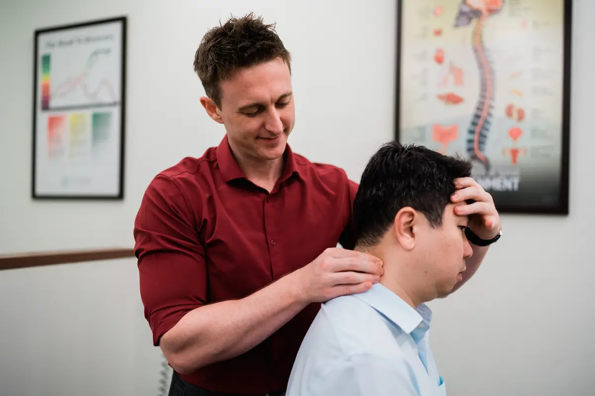 A clinician at Elite Spine Centres assessing a patient's neck.